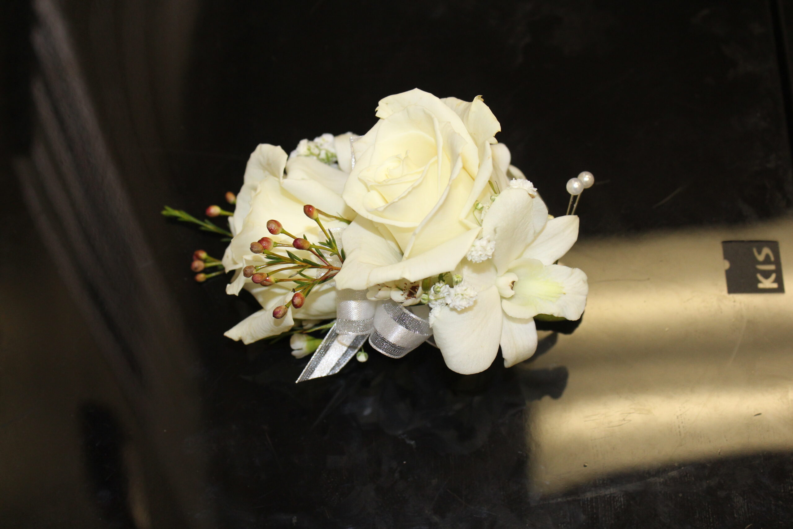 white roses with orchid corsage